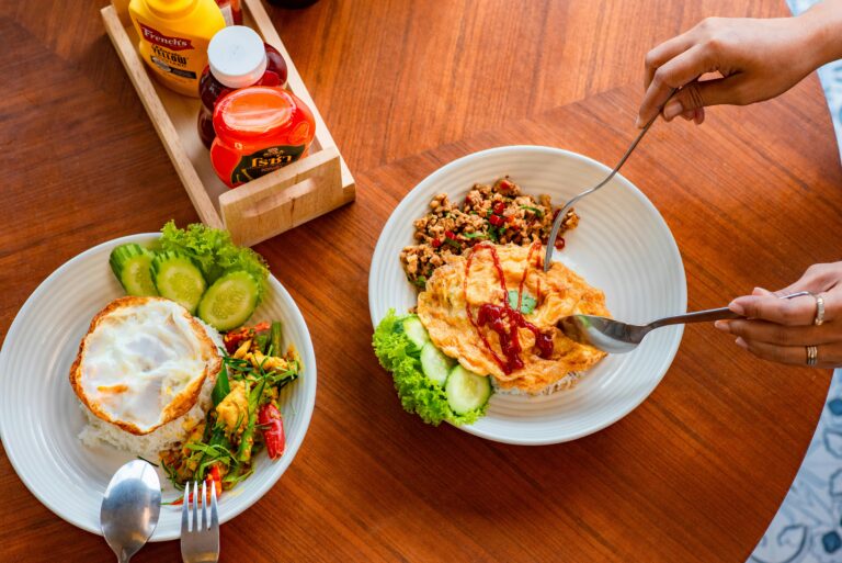 Top view of a Thai omelette and rice meal with sauces, perfect for breakfast or lunch.